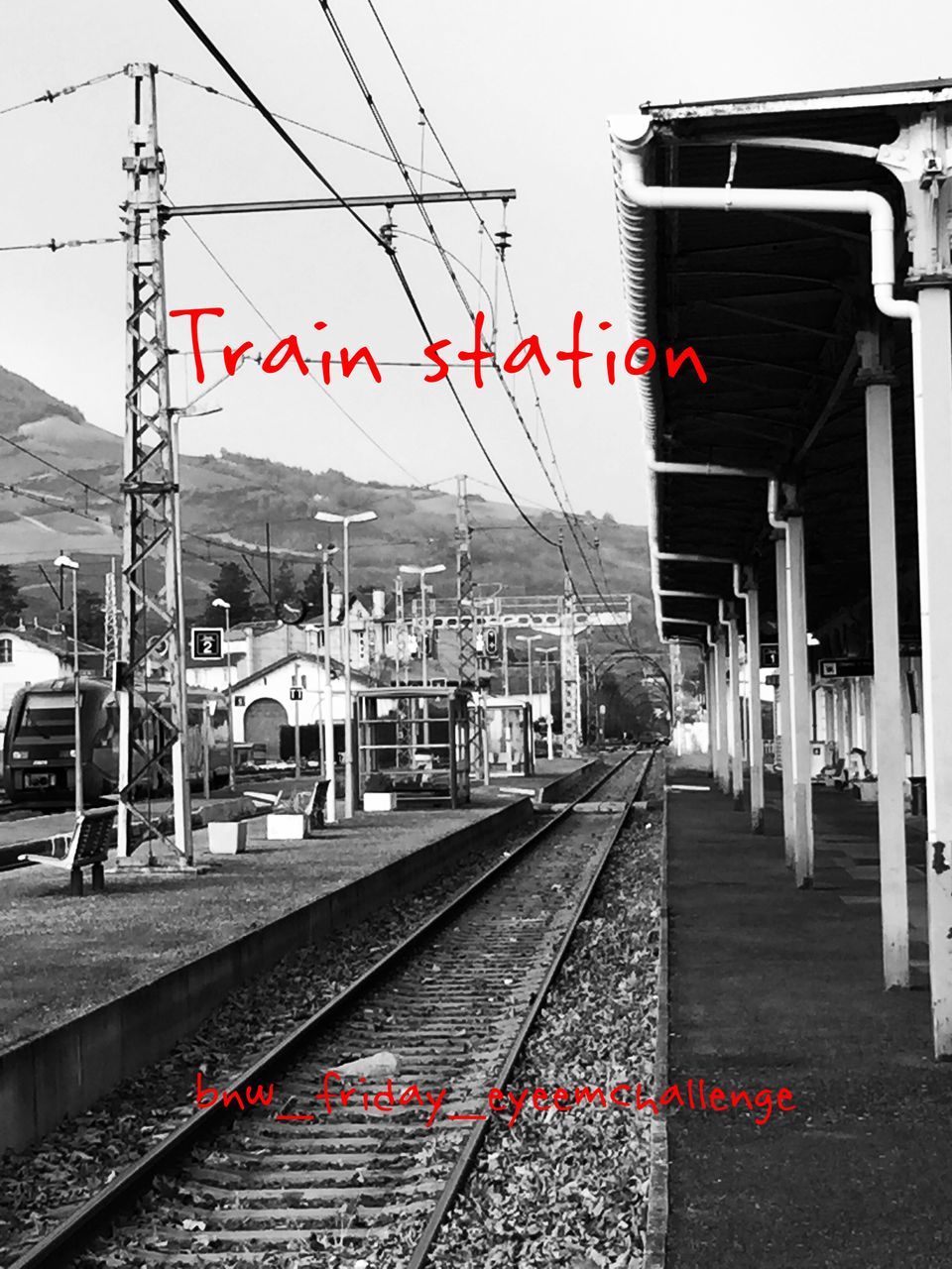 building exterior, architecture, built structure, red, transportation, the way forward, railroad track, sky, city, diminishing perspective, flag, rail transportation, railroad station platform, railroad station, street, clear sky, city life, day, outdoors, incidental people