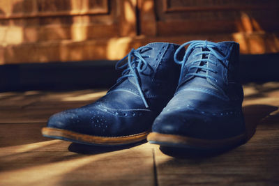 Close-up of shoes on wooden table