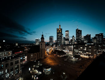 High angle view of illuminated buildings in city at night