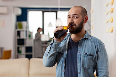 Man drinking beer at home