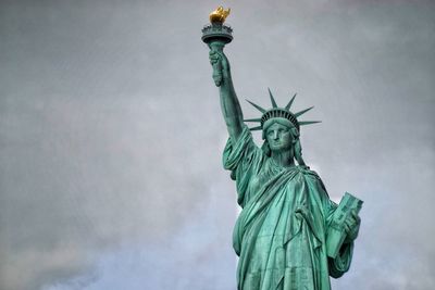 Low angle view of statue of liberty against sky