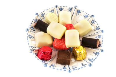 High angle view of dessert in plate against white background