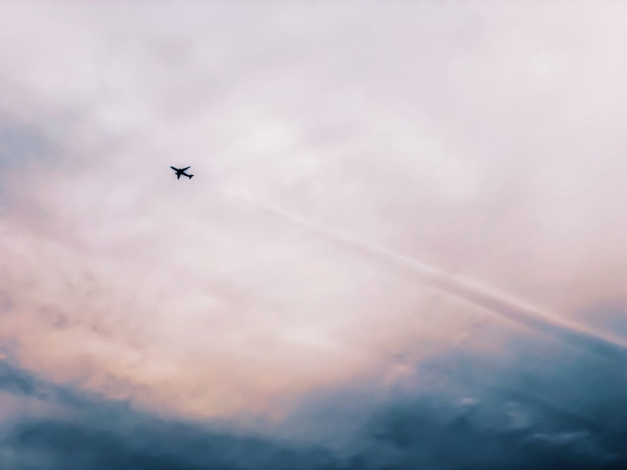 cloud - sky, flying, sky, air vehicle, low angle view, airplane, mode of transportation, transportation, mid-air, nature, no people, motion, on the move, travel, sunset, beauty in nature, scenics - nature, outdoors, day, silhouette, plane