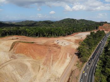 High angle view of road amidst trees against sky