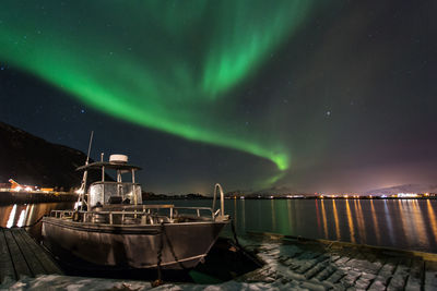 Boat moored at harbor at night