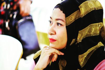 Close-up of thoughtful woman wearing striped hijab