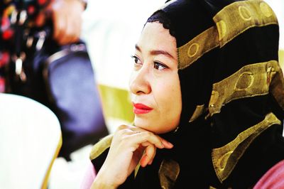 Close-up of young woman sitting outdoors