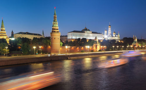 Illuminated buildings against sky in city