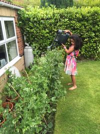 Full length of girl gardening