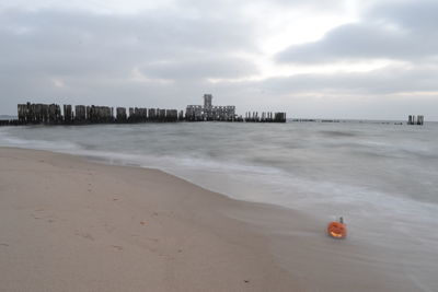 Scenic view of beach and buildings against sky