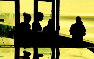 Silhouette of man sitting on bench