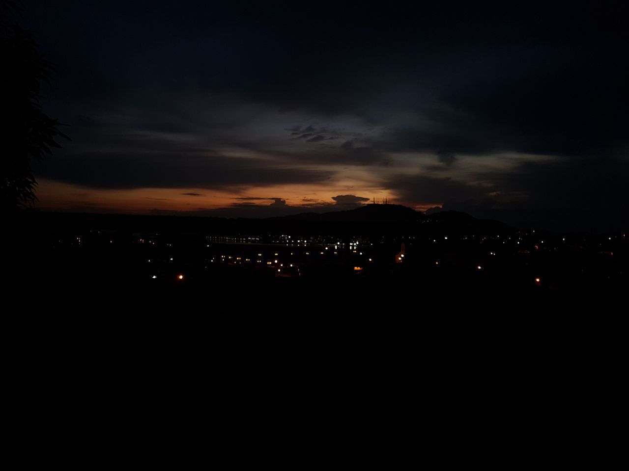 sky, cloud - sky, illuminated, no people, nature, scenics - nature, silhouette, city, beauty in nature, night, sunset, tranquility, architecture, copy space, environment, tranquil scene, dark, outdoors, building exterior, landscape, cityscape