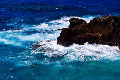 High angle view of rocks in sea