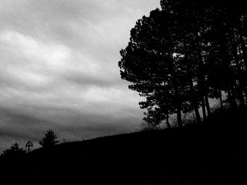 Low angle view of silhouette trees on field against sky