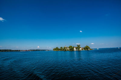 Scenic view of sea against blue sky