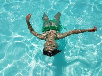 High angle view of woman swimming in pool