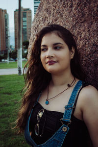 Portrait of beautiful woman standing against built structure