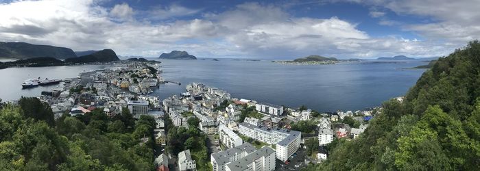 Panoramic view of city by sea against sky