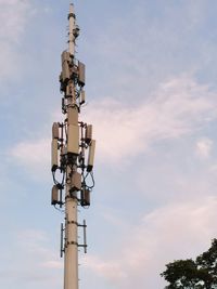 Low angle view of communications tower against sky