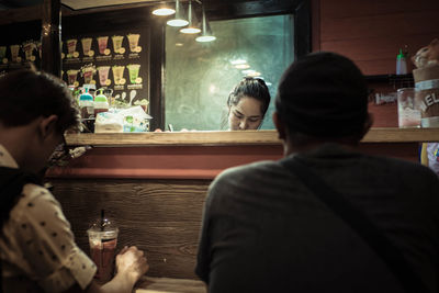 Rear view of couple sitting at restaurant