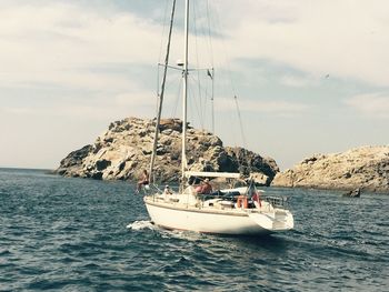 Boat sailing in sea against sky