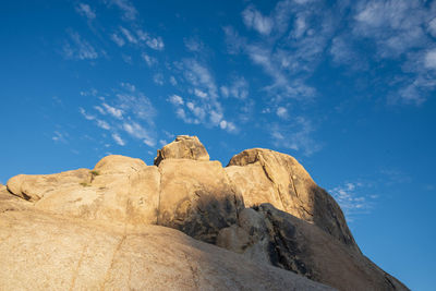 Low angle view of rock formations against sky