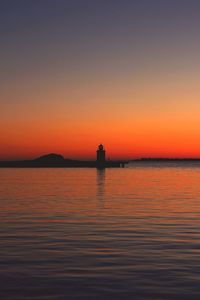 Scenic view of sea against orange sky