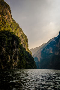 Scenic view of sea and mountains against sky