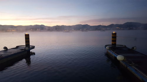 Scenic view of lake against sky at sunset