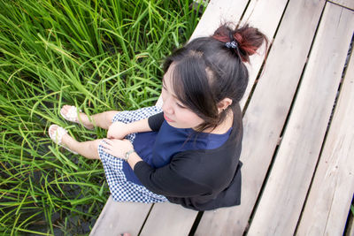 High angle view of woman sitting on field