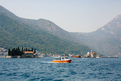 Scenic view of sea and mountains against sky