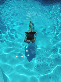 High angle view of woman swimming in pool