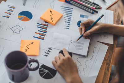 Close-up of business person working at desk in office