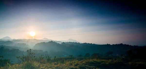 Scenic view of mountains against sky during sunset