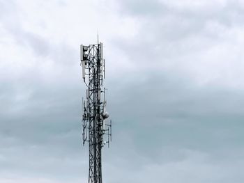 Low angle view of communications tower against sky