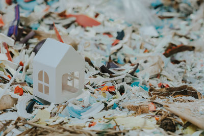 Close-up of model home on garbage