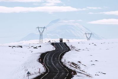 Road amidst snow covered field