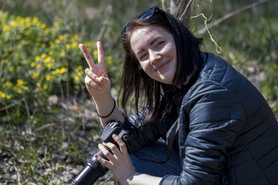 Portrait of smiling woman sitting outdoors