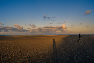 Scenic view of beach against sky during sunset