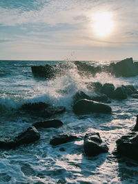 Water splashing in sea against sky
