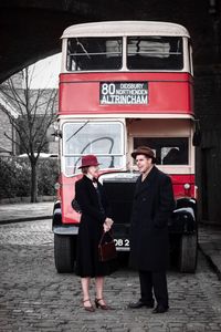 Man with woman standing in train