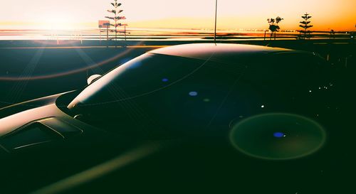 Airplane wing against sky during sunset