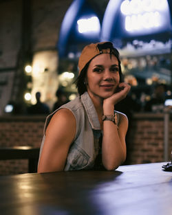 Portrait of young woman sitting outdoors