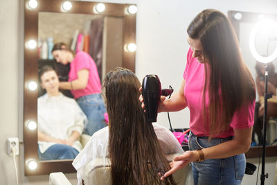 Rear view of woman standing at home