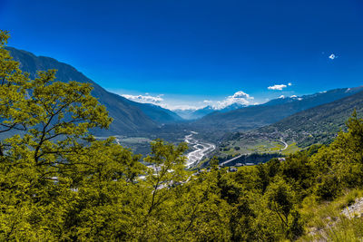 Scenic view of mountains against blue sky