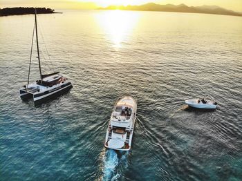 High angle view of sailboat sailing on sea against sky during sunset