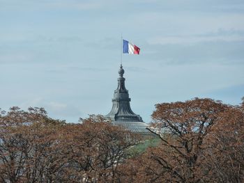 Low angle view of french flag on building against sky