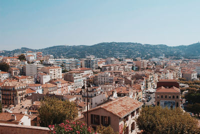 Buildings in city against clear sky