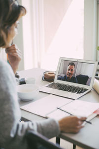 Coworkers having an online meeting at home