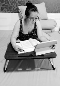 High angle view of woman sitting on table